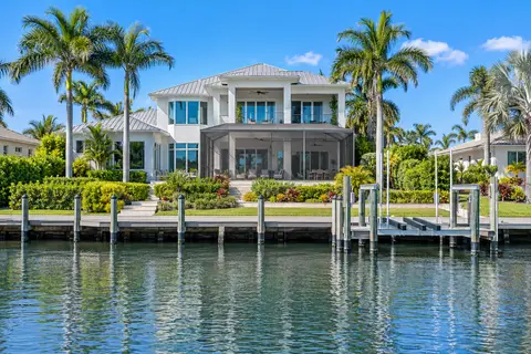 Contemporary waterfront home with a long dock and boat lift