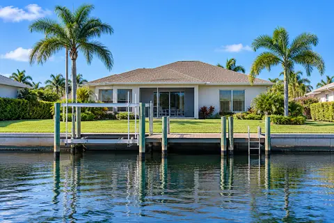 A tidy canal-front home with a dock and boat lift